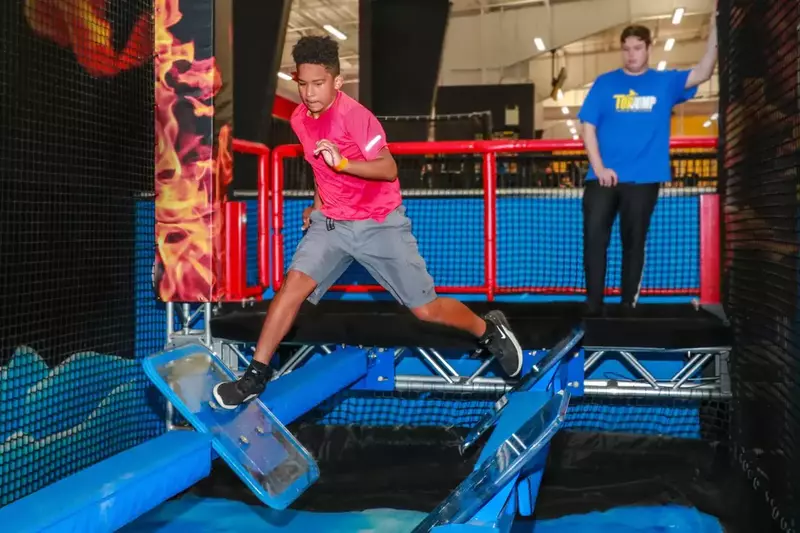 jumping through obstacle of Fire & Ice Ninja Course